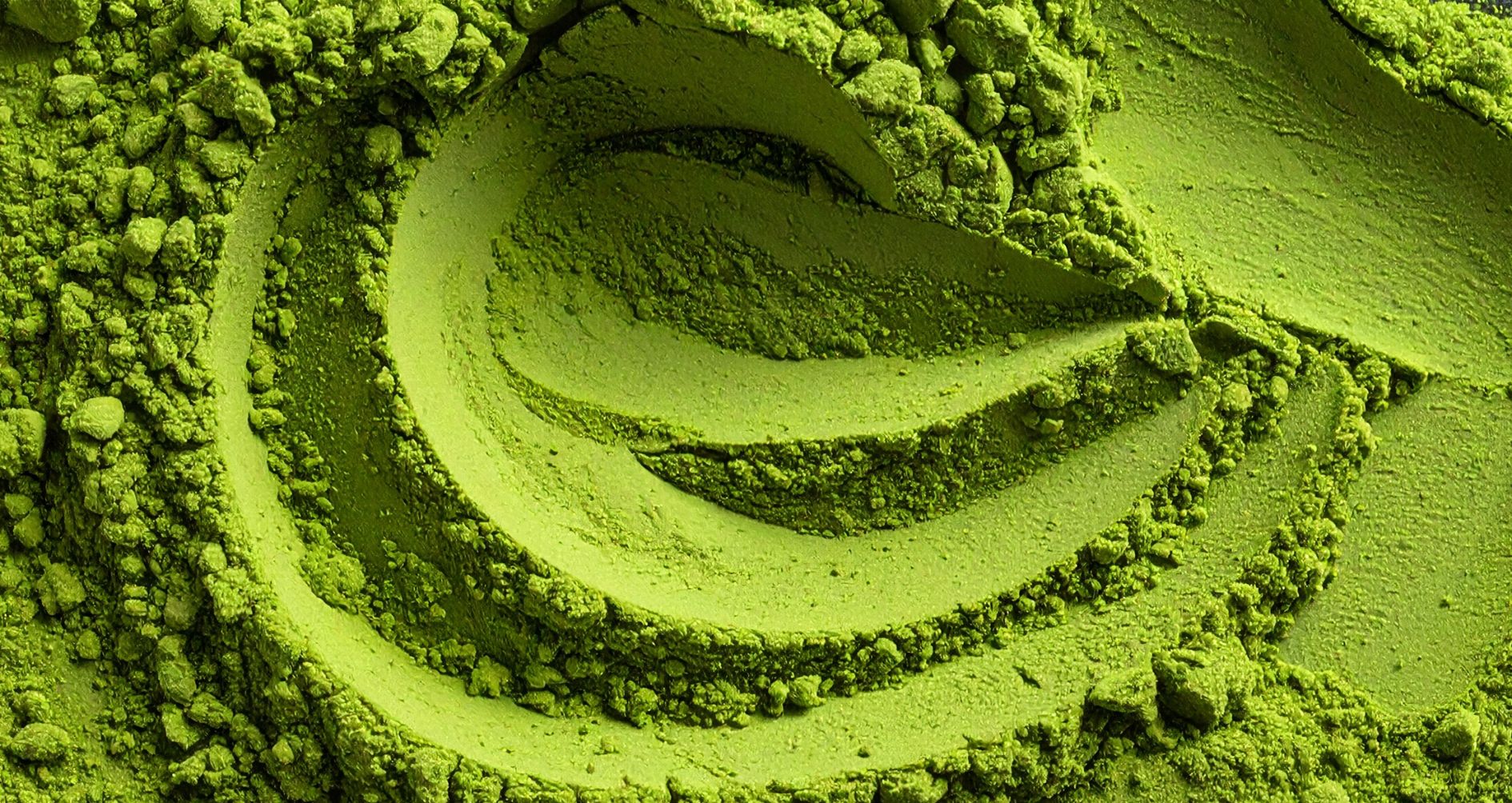 Close-up of premium Japanese matcha powder showing fine texture and natural variations in colour.